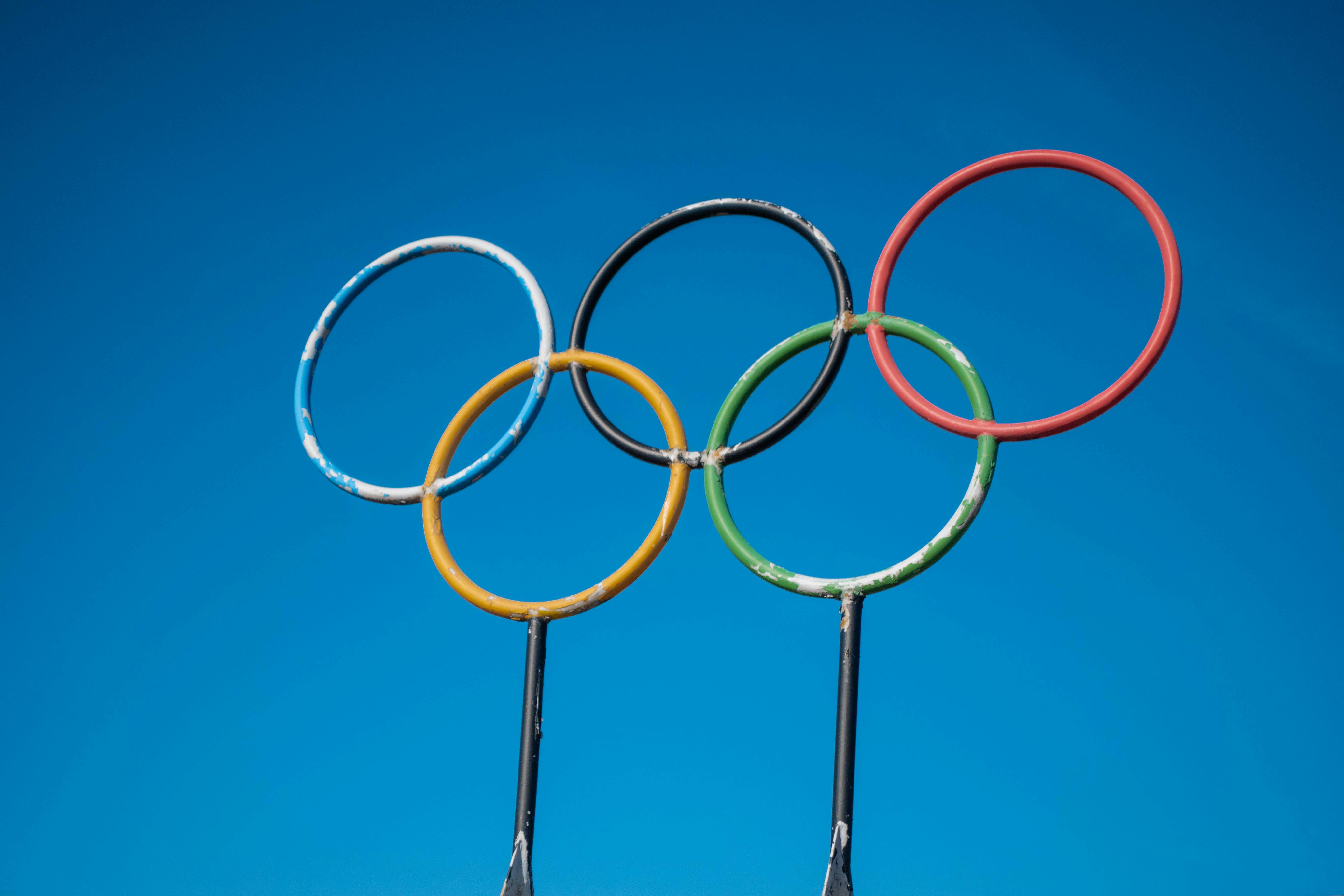 Olympic rings sculpture set against a clear blue sky in Lahti, Finland.
